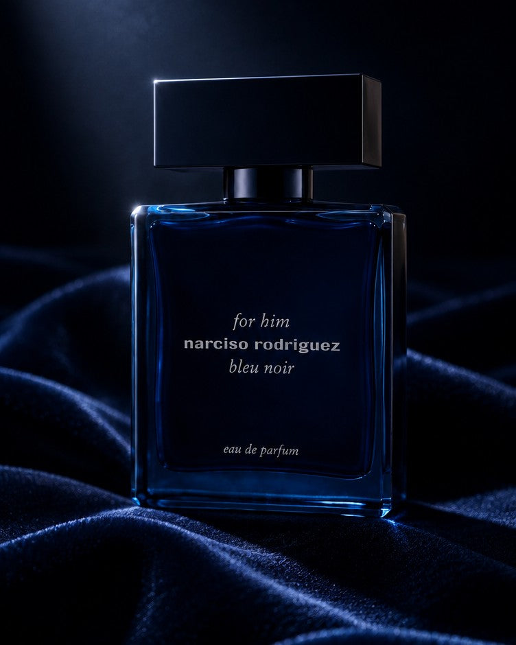 Narciso Rodriguez Bleu Noir bottle on deep navy velvet in low light